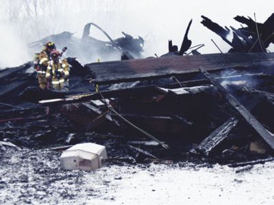 Smoldering ruins of the Austria Pavilion at Cockaigne Ski Lodge