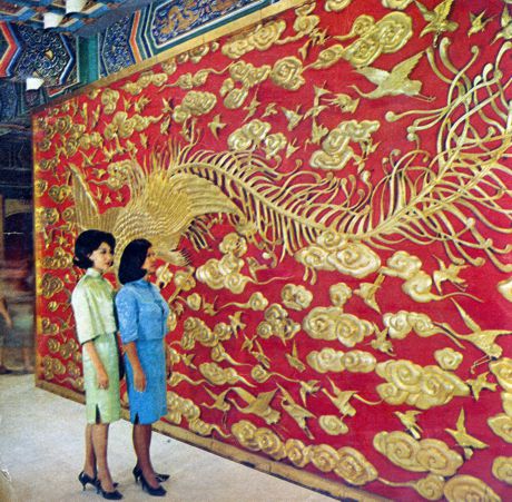 Two young ladies from Taiwan marvel at huge carved wood screen