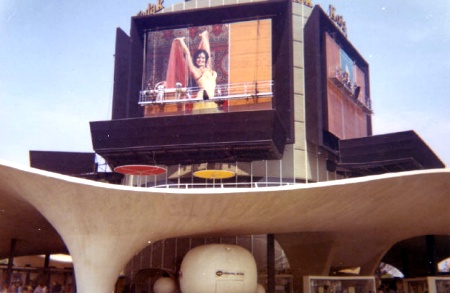 Workmen replace the giant photographs on Kodak's Picture Tower