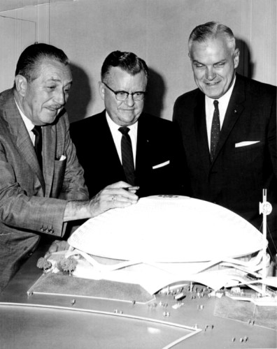 (Top) Wald Disney inspects a model of the GE Pavilion in 1963 along with Gerald L. Phillippe, President, General Electri