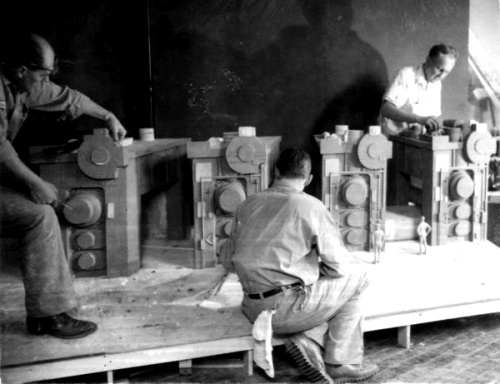 (Top) Factory "front" under construction in Medallion City. (Bottom) Workmen prepare the Steel Mill diorama for Medallio