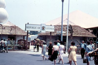 Bridge leads across a stream to Guinea's three buildings