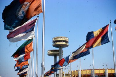 Towers of New York State's pavilion framed by gay colored flags