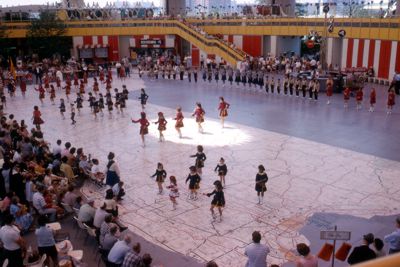 Mammoth terrazzo motoring map in New York State pavilion with school group performing