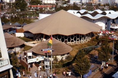 Three African huts house Guinea's industrial displays and souvenirs