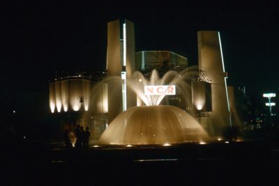 Night shot of two-story ribbed framed and concrete Pavilion of National Cash Register