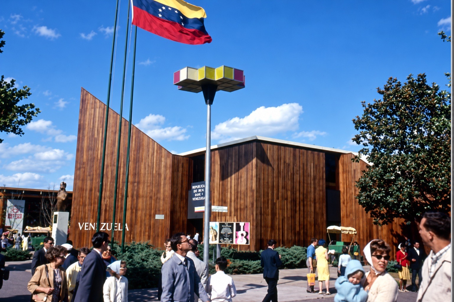Venezuela Pavilion with wood-slat facade and national flag