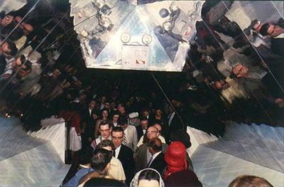 Kaleidoscopic view looking back down corridor of mirrors, leaving G.E. show