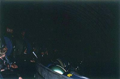 Cubicle-like conveyor seats carry visitors through Bell System ride